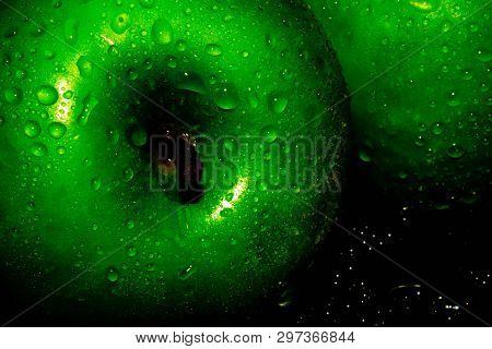 Green Ripe Apple With Water Droplets On A Dark Background, Closeup