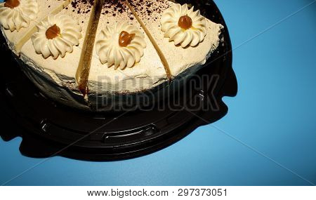 Caramel Biscuit Cake, Cut Into Portions. Blue Background