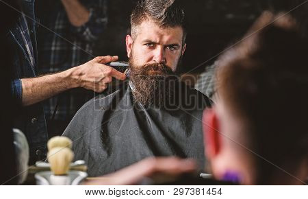 Reflexion Of Barbers Hand With Hair Clipper Trimming Nape Of Client. Hipster Bearded Client Getting 