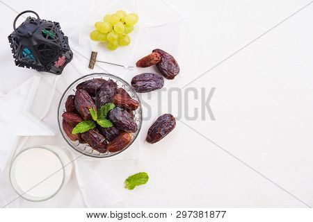 Ramadan Food And Drinks Concept. Ramadan Lantern With Milk, Dates Fruit, Grape And Mint Leaves On A 