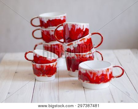 Red Tea Coffee Cups On White Wooden Table Over Grunge Background.
