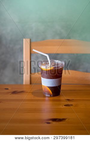 Iced Coffee Mixed With Orange Juice And Piece Of Fresh Orange