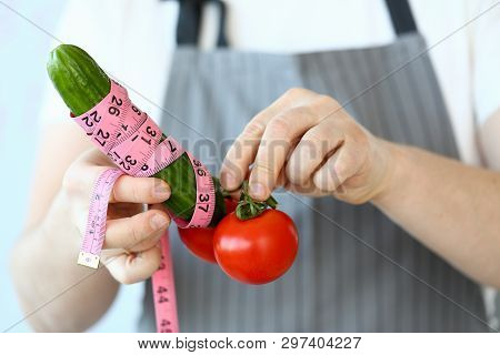 Culinary Chef Measure Green Cucumber Penis Size. Man In Apron With Tomato And Cucumber Wrapped In Ce