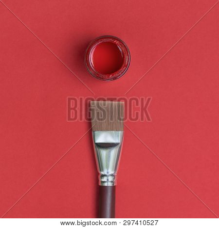 Paint Brush And Pot Of Red Paint, Isolated On A Red Background. Art Concept.