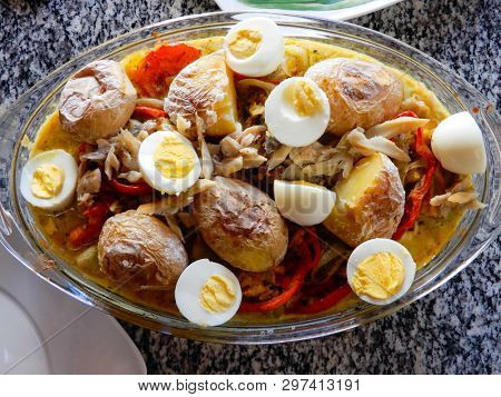 Cod with eggs olives, potato and vegetables