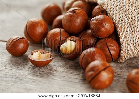 Macadamia Nut On A Wooden Table In A Bag, Closeup, Top View