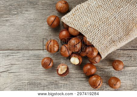 Macadamia Nut On A Wooden Table In A Bag, Closeup, Top View