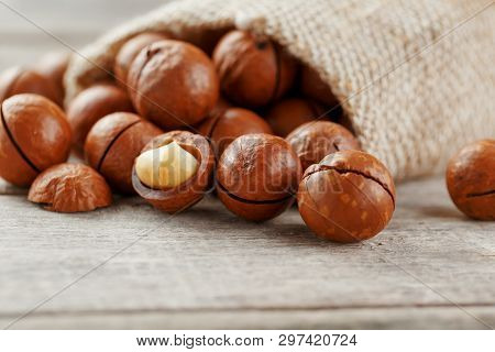 Macadamia Nut On A Wooden Table In A Bag, Closeup, Top View