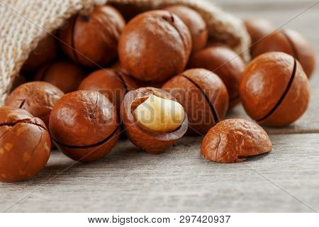 Macadamia Nut On A Wooden Table In A Bag, Closeup, Top View