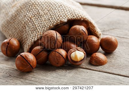 Macadamia Nut On A Wooden Table In A Bag, Closeup, Top View