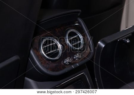 A Close-up View Of A Part Of The Interior Of A Modern Luxury Car With A View Of The Two Rear Central