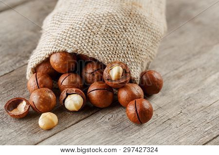 Macadamia Nut On A Wooden Table In A Bag, Closeup, Top View