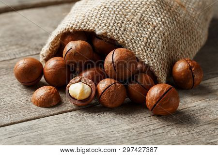 Macadamia Nut On A Wooden Table In A Bag, Closeup, Top View