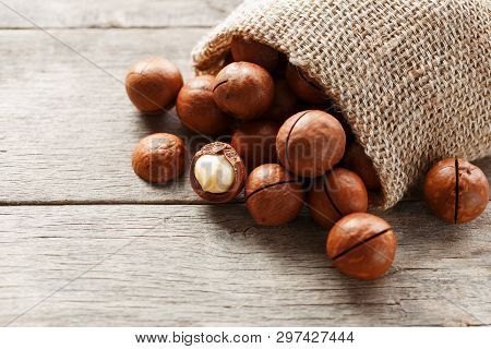 Macadamia Nut On A Wooden Table In A Bag, Closeup, Top View