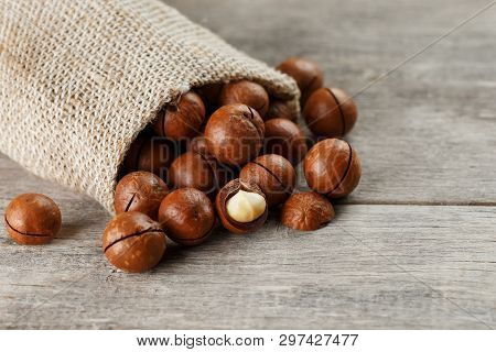 Macadamia Nut On A Wooden Table In A Bag, Closeup, Top View