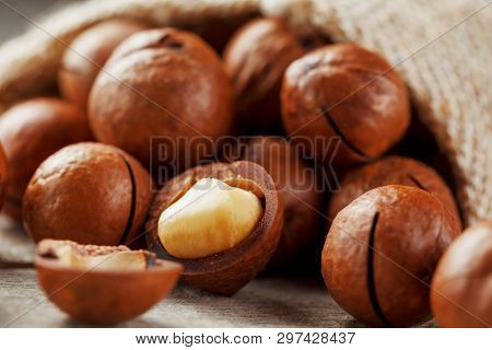 Macadamia Nut On A Wooden Table In A Bag, Closeup, Top View