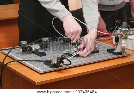 Engineers Connect Wires Control Panel With A Small Test Bench For Experiments