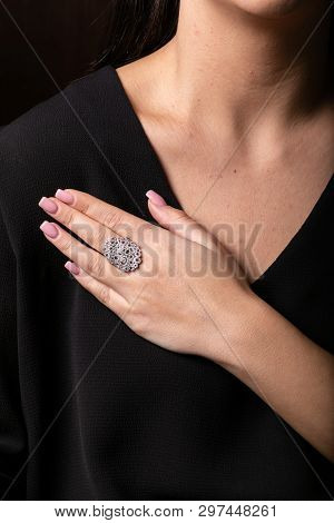Womens Silver Ring With Stones, Lots Of Circles On The Finger, On A Black Background.