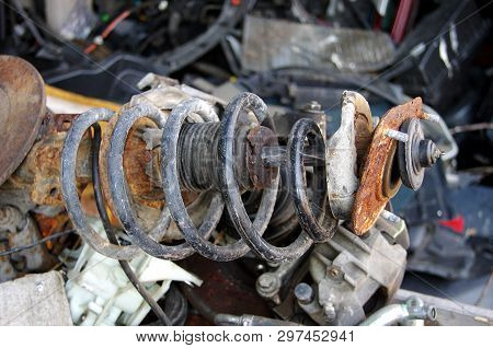 Old And Rusty Car Parts Like Brake Discs,axles And Engines.