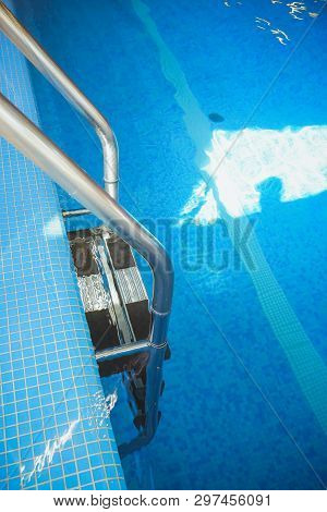 Metal Swimming Pool Steps.interior Of Sport Hall.stainless Steel Swimming Pool. Hand Rails Of Swimmi