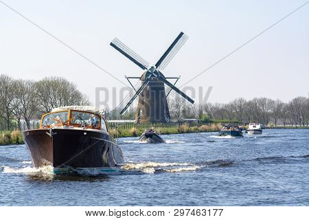 Waterways Of North Holland With Boats And View On Traditional Dutch Mill, Spring Landscape