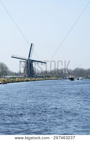 Waterways Of North Holland With Boats And View On Traditional Dutch Mill, Spring Landscape
