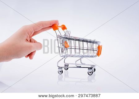 Hand Holding A Cart On A White Background