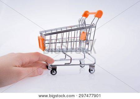 Hand Holding A Cart On A White Background
