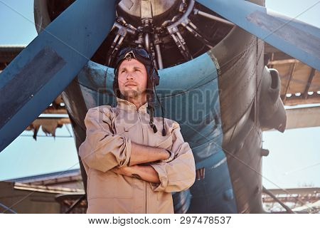 Military Young Pilot Is Thoughtfully Looking Up. He Is Standing Near Small Jet, Just Under The Prope