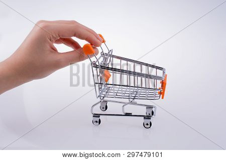 Hand Holding A Cart On A White Background