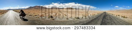 Pamir Highway Or Pamirskij Trakt. Panoramic View With Two Bikers. Landscape Around Pamir Highway M41