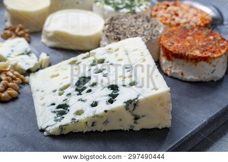 Assortment Of French Fresh White Soft Goat Cheeses With Different Tastes Topping Made With Herbs, Pa