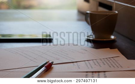Proofreading Paper On Table With Writing Hand