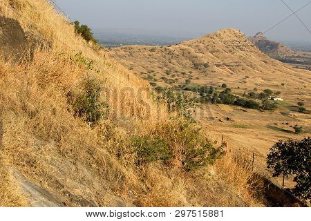 Aerial View Of Landscape Of Hills Covered With Dry Grass Viewed From Girijatmak Vinayaka Temple At L