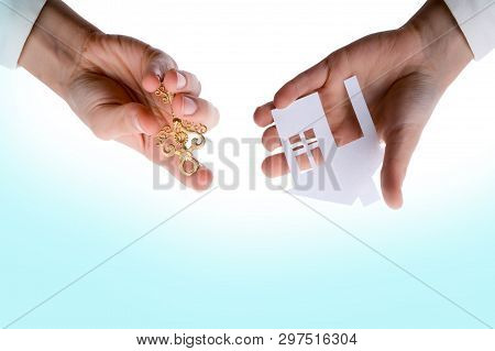 Hand Holding An Isolated Paper House With A White Background