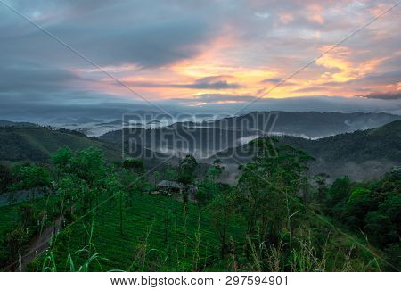 Sunrise From Hilltop With Low Clouds And Orange Light Of Sun. Image Taken From Hill Top Showing Dawn