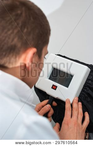 Doctor Trichologist Diagnoses The Structure Of The Hair With A Special Tool. Concept Of Good Health