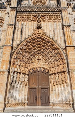 Batalha, Portugal. Portal of Batalha Abbey aka Monastery of Santa Maria da Vitoria, with tympanum, archivolts and lintel and other Gothic and Manuelino elements.