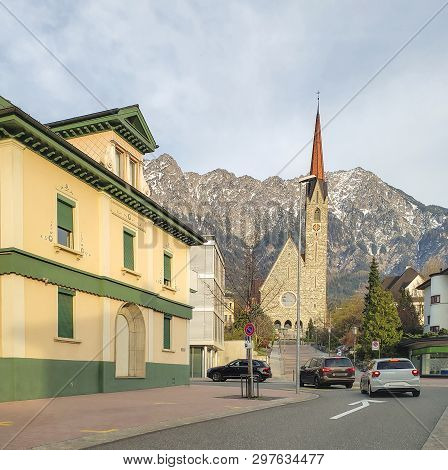 St. Laurentius New Parish Church - Schaan-vaduz, Liechtenstein. Fragment Of A City Street. In The Ba