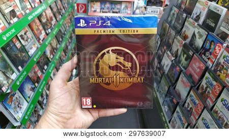 Bratislava, Slovakia, April 25, 2019: Man Holding Mortal Kombat 11 Premium Edition Videogame On Sony