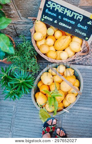 Wicker Basket Full Of Lemons On The Italian Street Od Corniglia