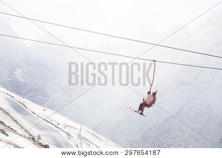 Dombai, Russia - January 3, 2014: People Are Lifting On Open Lft High Up In Caucasus Mountains