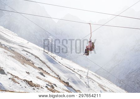 Dombai, Russia - January 3, 2014: People Are Lifting On Open Lft High Up In Caucasus Mountains