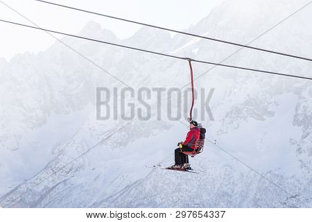 Dombai, Russia - January 3, 2014: People Are Lifting On Open Lft High Up In Caucasus Mountains