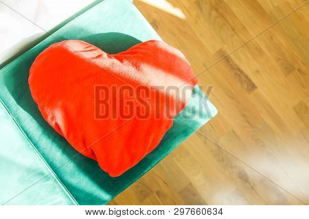 Heart Shaped Small Decorative Pillow On Soft Green Pouffe. Modern Interior Cozy Design Element
