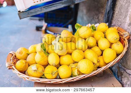 Wicker Basket Full Of Lemons On The Italian Street Od Corniglia