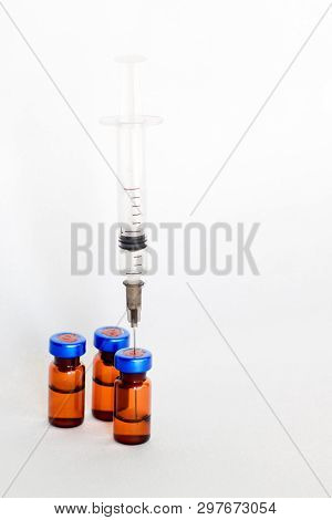 Medical Vials, Ampules For Injection With A Syringe On A White Background