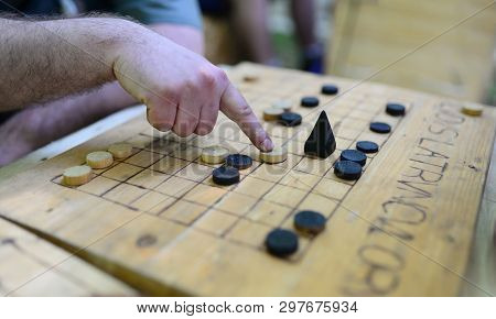 Roman Soldier Playing A Game Named Ludus Latrunculorum