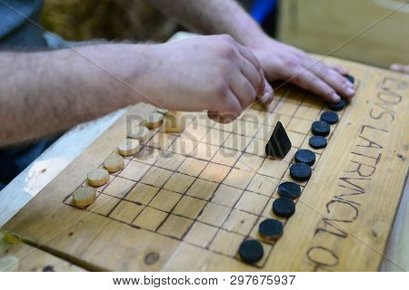 Roman Soldier Playing A Game Named Ludus Latrunculorum