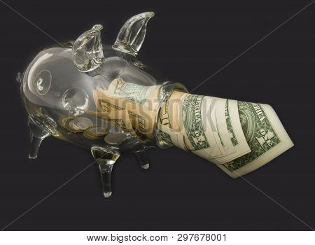 A See Through Piggy Bank With Money Coins